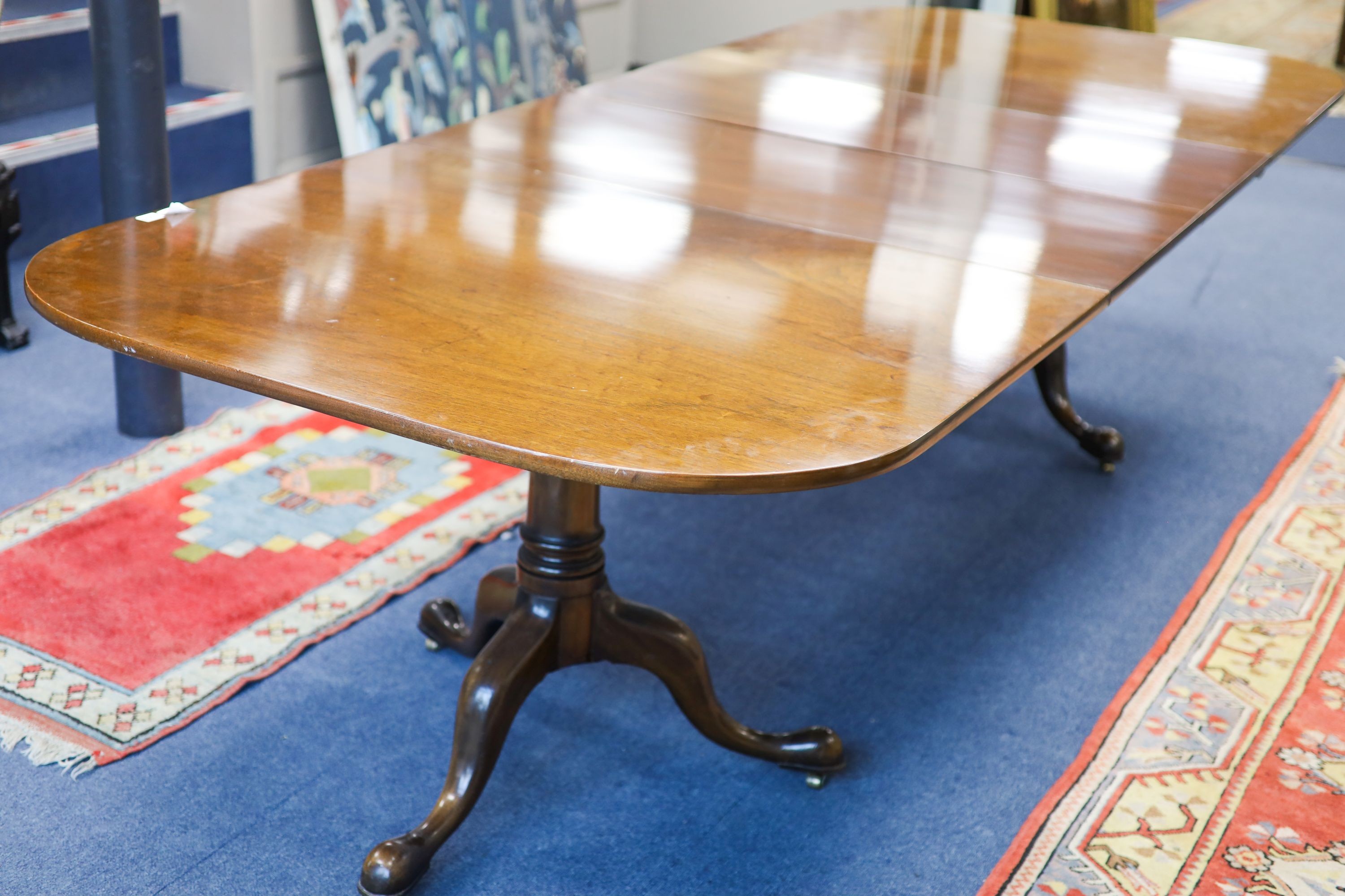 A George III style mahogany two pillar extending dining table, length 276cm extended, two spare leaves, width 114cm, height 72cm